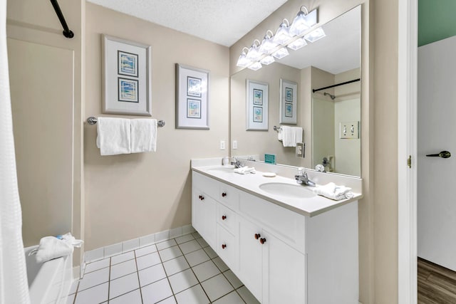 bathroom featuring vanity, a textured ceiling, and tile patterned flooring