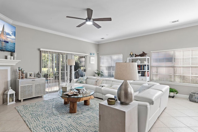 living room with crown molding, ceiling fan, and light tile patterned floors