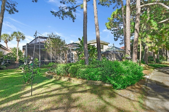 view of yard with glass enclosure