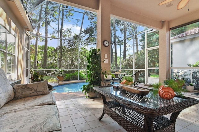 sunroom with a pool and ceiling fan