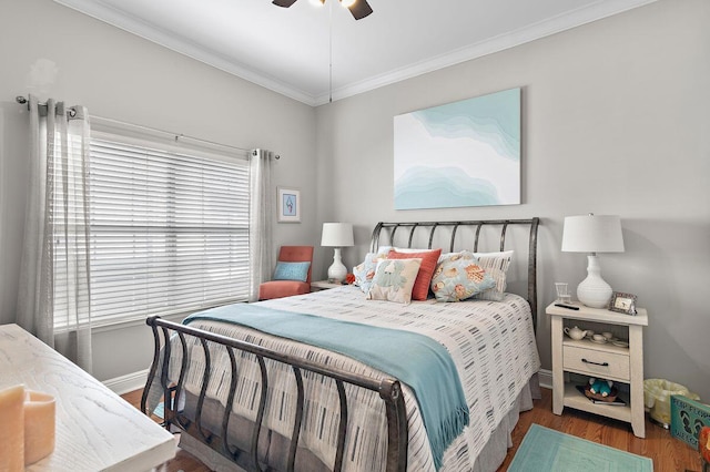 bedroom with dark hardwood / wood-style floors, ornamental molding, and ceiling fan