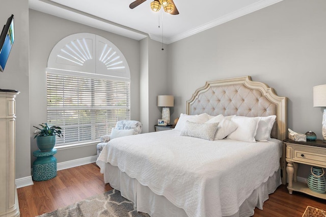 bedroom with ceiling fan, ornamental molding, and dark wood-type flooring