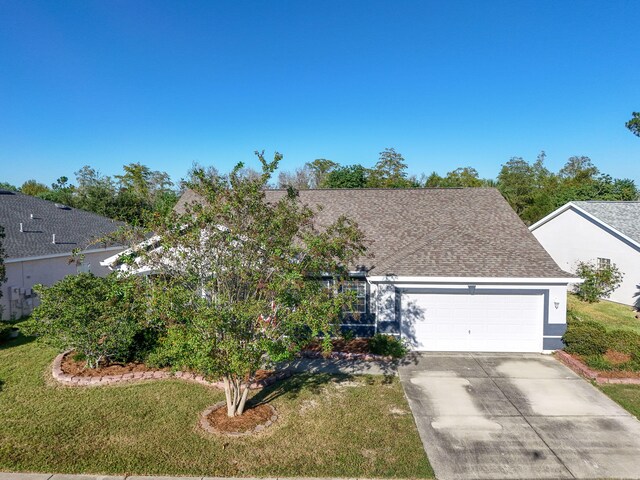 view of front of home with a front lawn and a garage