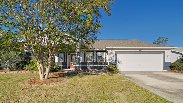 view of front of house with a front yard and a garage