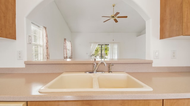 kitchen featuring ceiling fan and sink