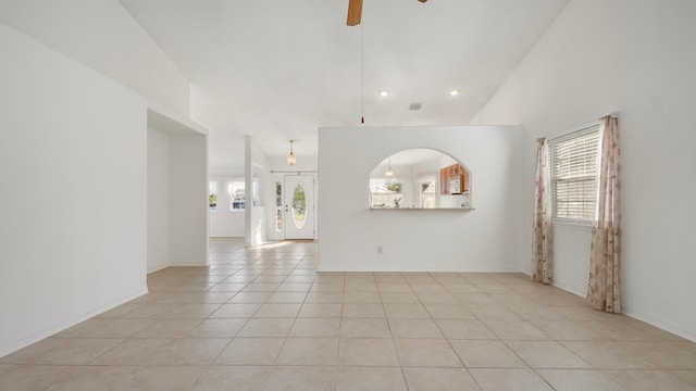 spare room with high vaulted ceiling, ceiling fan, and light tile patterned floors