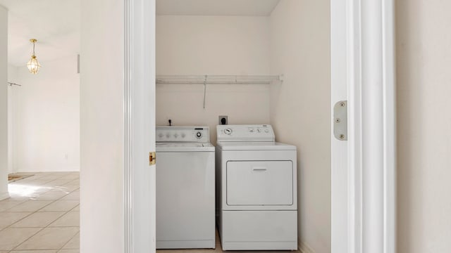 laundry area with light tile patterned flooring and separate washer and dryer