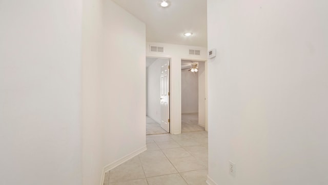 hall featuring light tile patterned floors