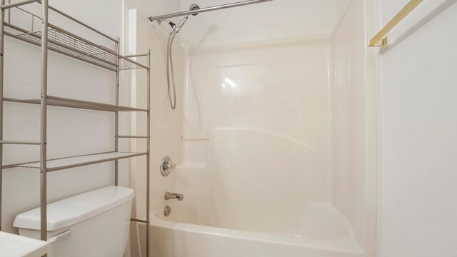 bathroom with shower / bath combination and toilet