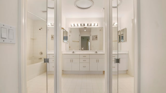 bathroom with tiled shower / bath, tile patterned floors, and vanity