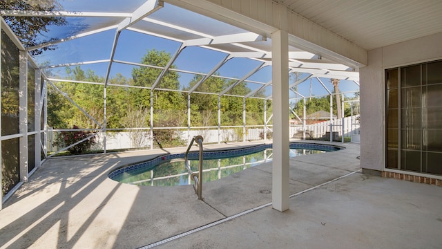 view of pool featuring glass enclosure and a patio area