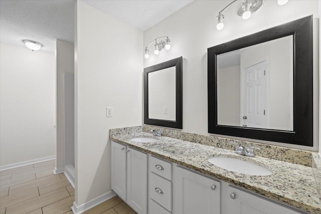 bathroom with vanity and a textured ceiling