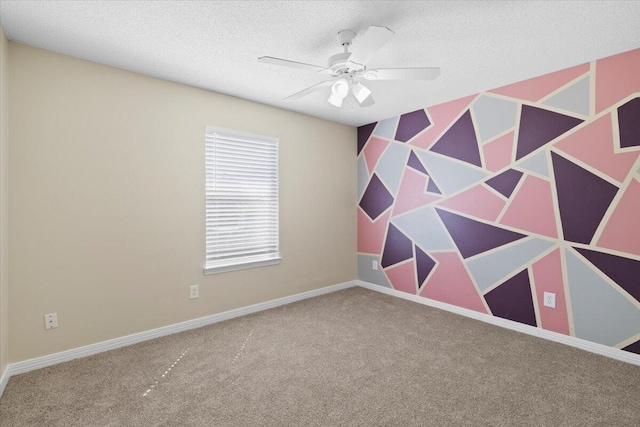 carpeted empty room with ceiling fan and a textured ceiling