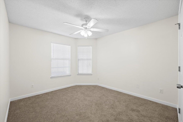 unfurnished room with ceiling fan, carpet floors, and a textured ceiling