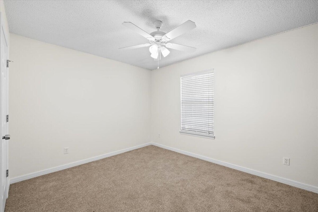 spare room featuring light carpet, a textured ceiling, and ceiling fan