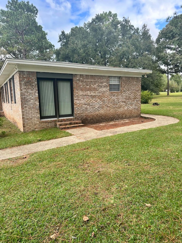 rear view of property with a lawn