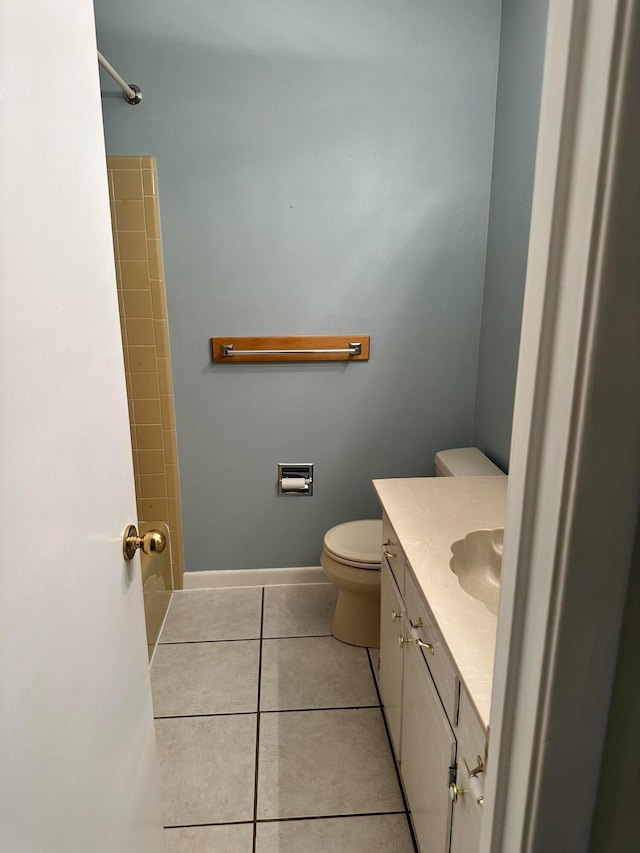 bathroom with tile patterned floors, vanity, toilet, and a shower