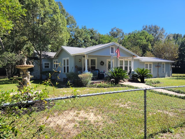 ranch-style home with a front yard and covered porch