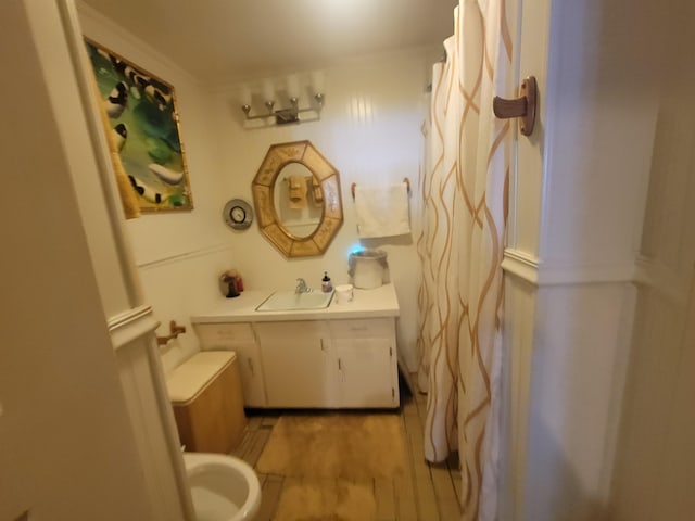 full bathroom featuring toilet, vanity, and wood finished floors