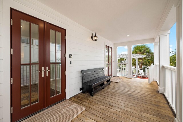 sunroom / solarium featuring french doors