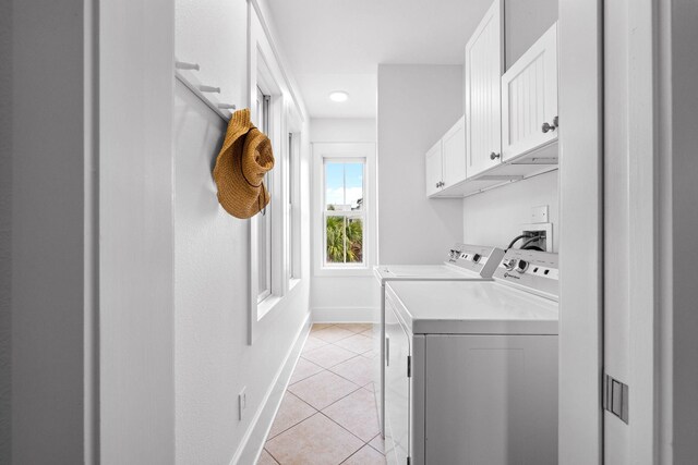 washroom featuring light tile patterned floors, cabinets, and independent washer and dryer