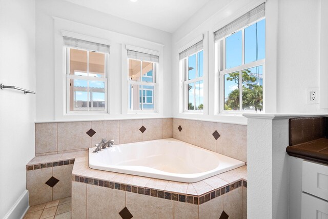 bathroom featuring tile patterned floors and tiled bath