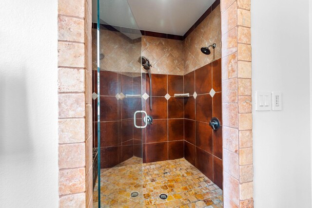 bathroom with a shower with door