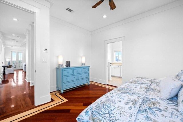 bedroom featuring ensuite bathroom, ornamental molding, hardwood / wood-style flooring, and ceiling fan