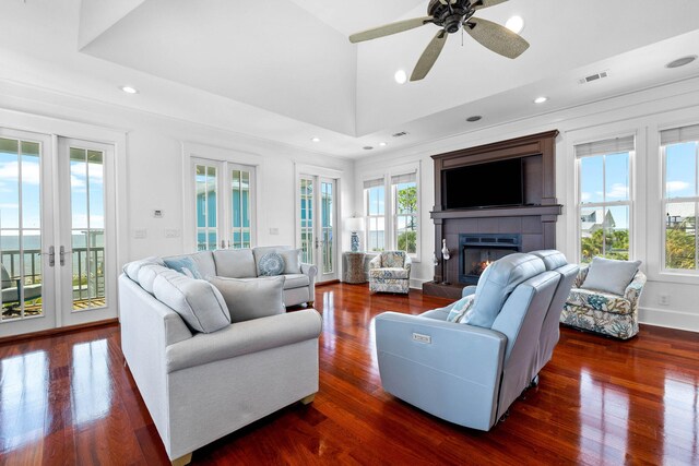 living room with dark wood-type flooring, french doors, and ceiling fan