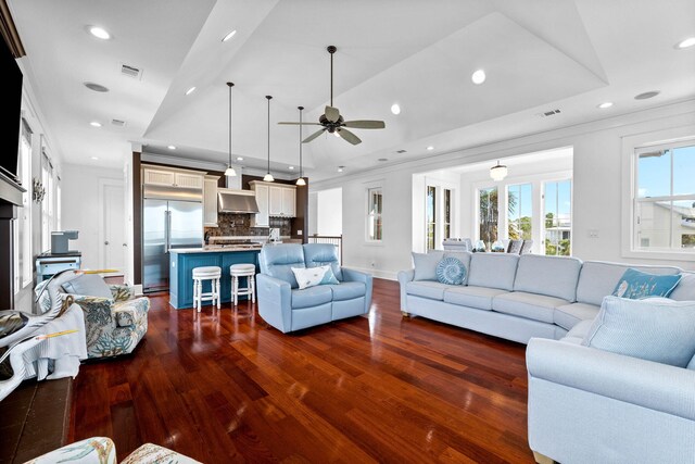 living room featuring lofted ceiling, dark hardwood / wood-style flooring, and ceiling fan