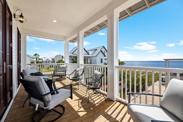 wooden terrace featuring a water view