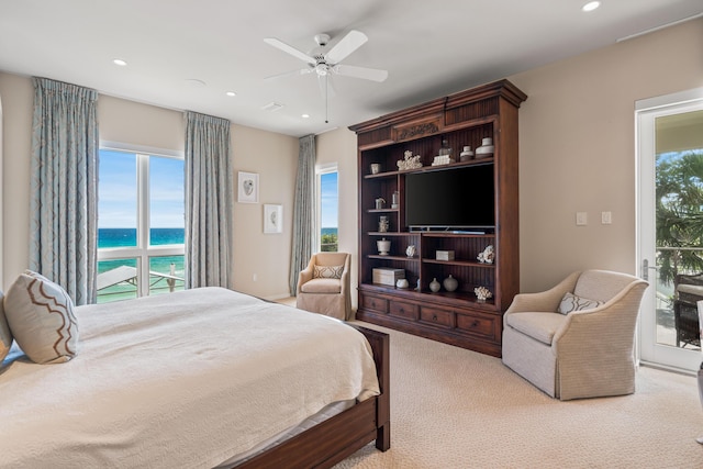 carpeted bedroom with ceiling fan and multiple windows