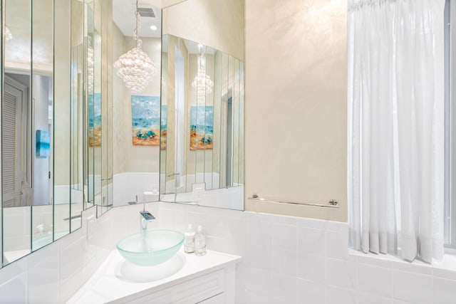 bathroom with vanity and an inviting chandelier