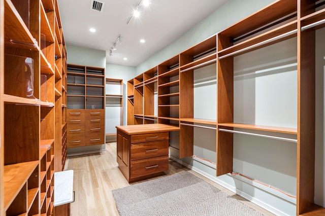 walk in closet featuring light hardwood / wood-style floors