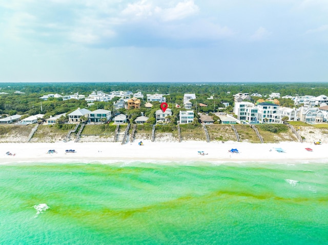 birds eye view of property featuring a beach view and a water view