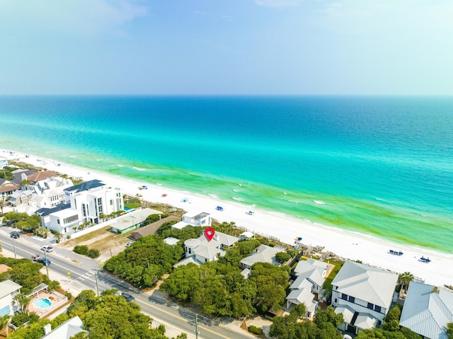 birds eye view of property with a water view and a view of the beach