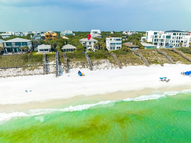 bird's eye view with a water view and a view of the beach