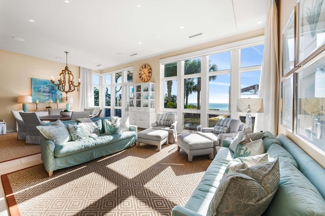 living room featuring a water view and an inviting chandelier