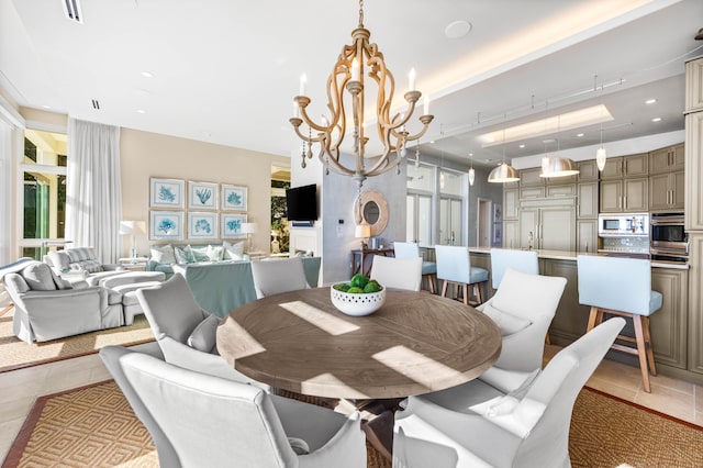 dining area featuring light tile patterned floors and a chandelier