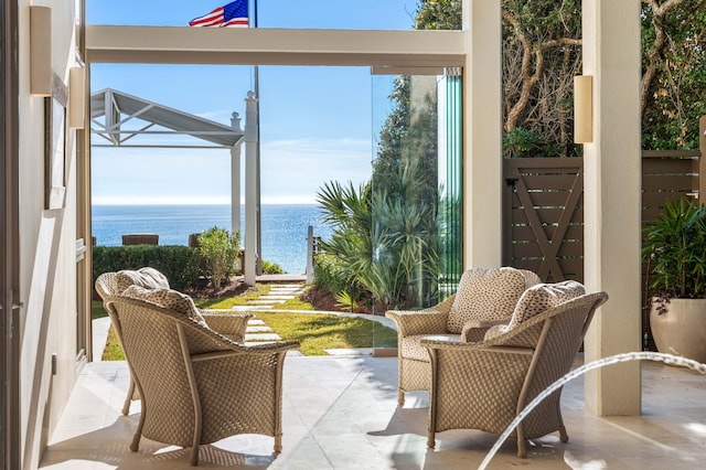 sunroom / solarium featuring a water view