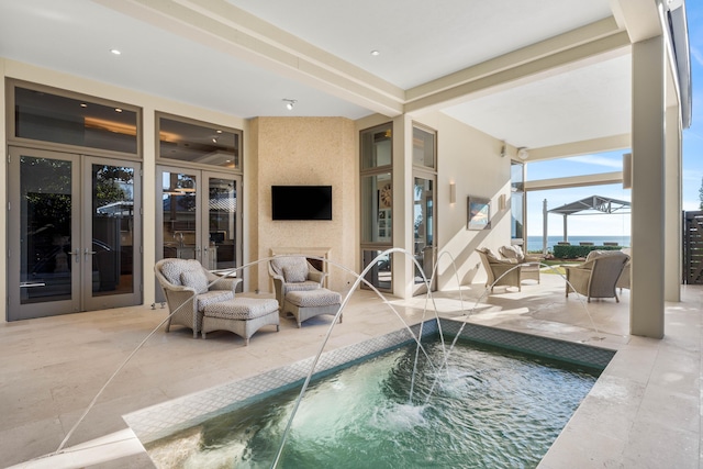 view of pool featuring a jacuzzi, french doors, and pool water feature