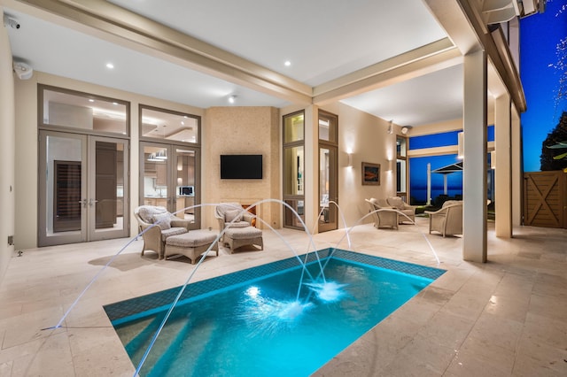 view of swimming pool with french doors, pool water feature, and a hot tub