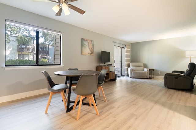 dining space with light hardwood / wood-style flooring and ceiling fan