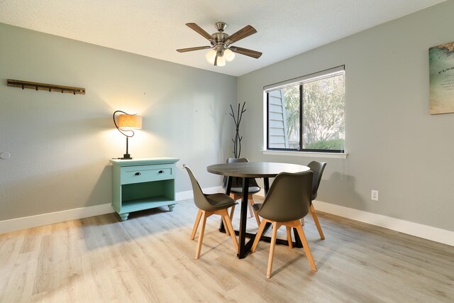 dining area with ceiling fan and light hardwood / wood-style floors