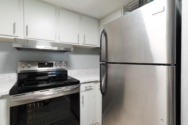 kitchen with stainless steel appliances, white cabinets, and a textured ceiling