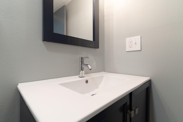 bathroom featuring vanity and a textured ceiling