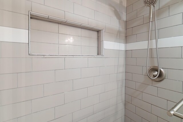 bathroom with tiled shower