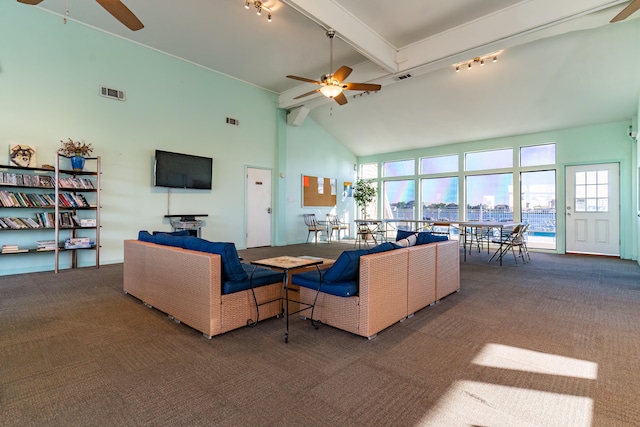 carpeted living room with ceiling fan, a wealth of natural light, rail lighting, and beam ceiling