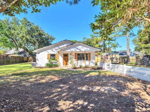 view of front of home featuring cooling unit and a front lawn