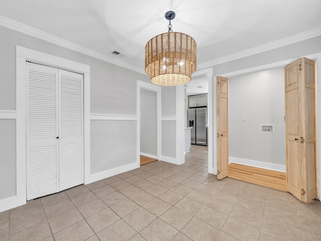 unfurnished dining area featuring light tile patterned flooring, a chandelier, and ornamental molding